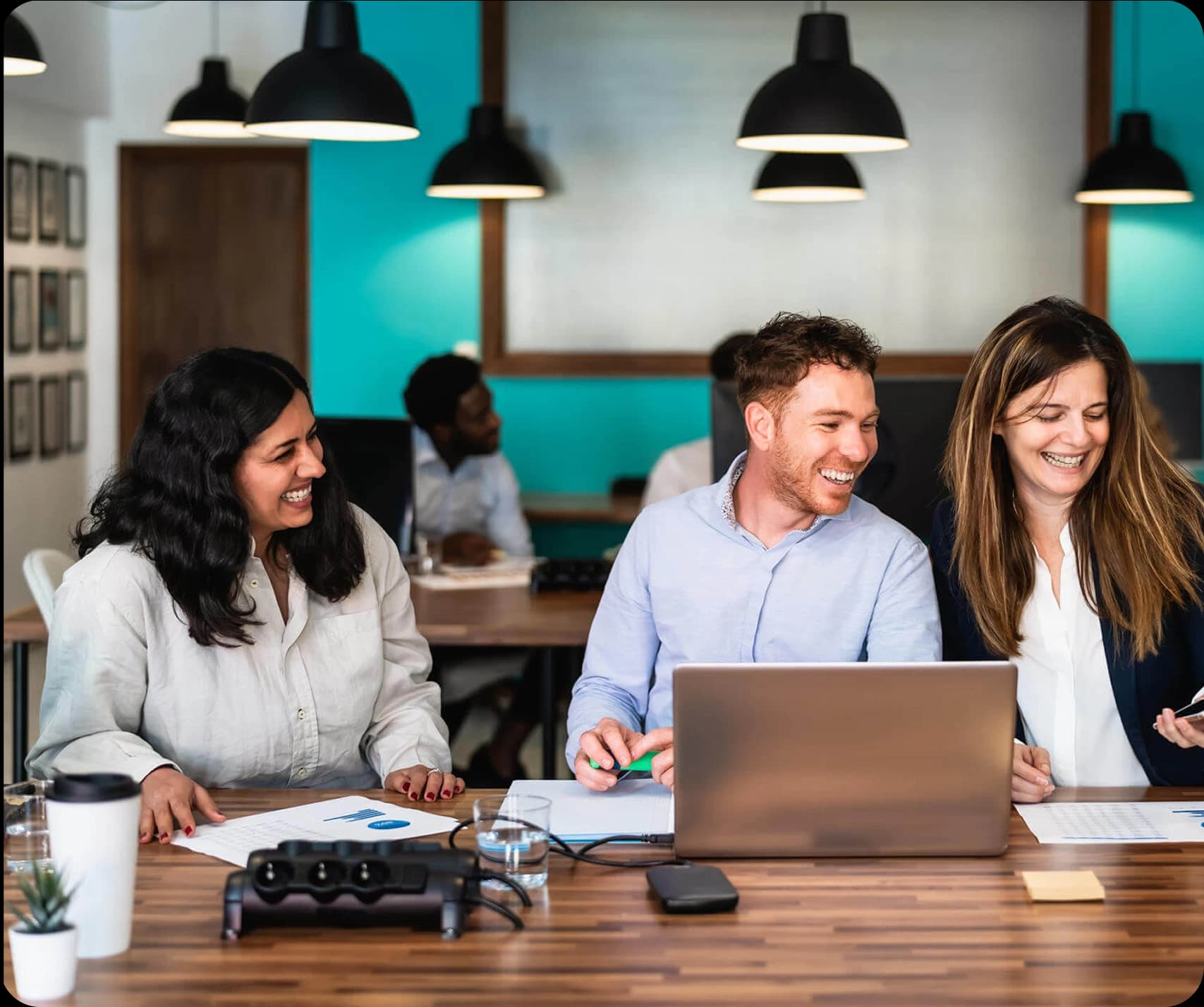 A team reviewing payroll and compliance work together