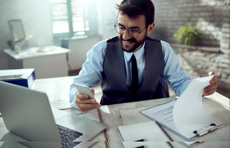 Payroll manager reviewing salary documents and calculations